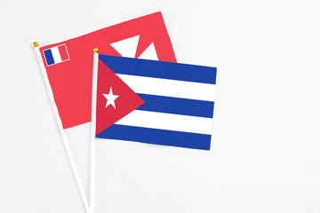Cuba and Wallis And Futuna stick flags on white background. High quality fabric, miniature national flag. Peaceful global concept.White floor for copy space.
