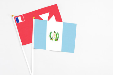 Guatemala and Wallis And Futuna stick flags on white background. High quality fabric, miniature national flag. Peaceful global concept.White floor for copy space.