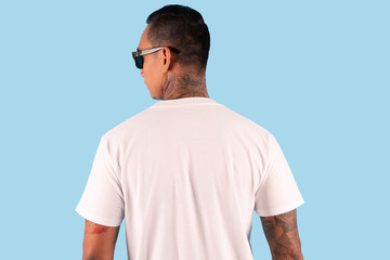 A man wearing white t shirt in back side view isolated on background. Hipster man with tattoo wearing white long sleeve t shirt, ready for your mock up template or background