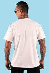 Man with white t shirt in back view side isolated on background. Hipster man with tattoo wearing white t shirt ready for your mock up template or background.