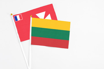 Lithuania and Wallis And Futuna stick flags on white background. High quality fabric, miniature...