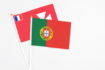 Portugal and Wallis And Futuna stick flags on white background. High quality fabric, miniature national flag. Peaceful global concept.White floor for copy space.