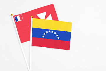 Venezuela and Wallis And Futuna stick flags on white background. High quality fabric, miniature national flag. Peaceful global concept.White floor for copy space.