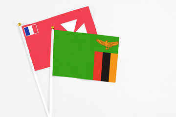 Zambia and Wallis And Futuna stick flags on white background. High quality fabric, miniature national flag. Peaceful global concept.White floor for copy space.
