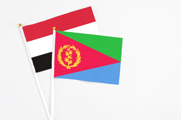 Eritrea and Yemen stick flags on white background. High quality fabric, miniature national flag. Peaceful global concept.White floor for copy space.