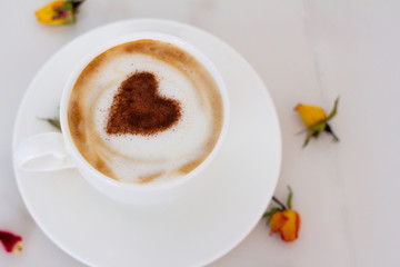 cup of coffee with whipped cream on white background