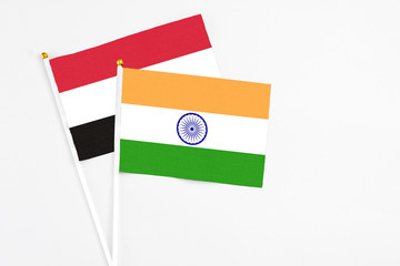 India and Yemen stick flags on white background. High quality fabric, miniature national flag. Peaceful global concept.White floor for copy space.