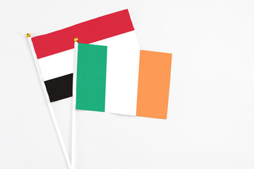 Ireland and Yemen stick flags on white background. High quality fabric, miniature national flag. Peaceful global concept.White floor for copy space.