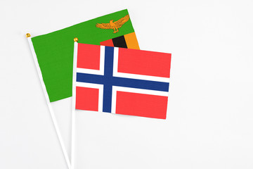 Bouvet Islands and Zambia stick flags on white background. High quality fabric, miniature national flag. Peaceful global concept.White floor for copy space.