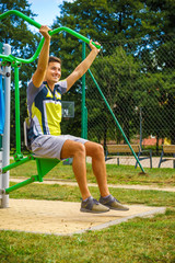 Man flexing arm in outdoor gym