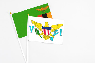 United States Virgin Islands and Zambia stick flags on white background. High quality fabric, miniature national flag. Peaceful global concept.White floor for copy space.