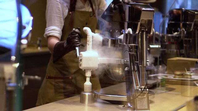 Chicago,IL/USA-November 15th 2019: Starbucks baristas are busy making coffee and frozen drinks during the grand opening of the worlds largest Starbucks downtown. the smoke slowly covers the counters