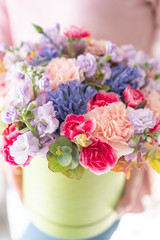 European floral shop. Floral bunch in round box. Bouquet of beautiful Mixed flowers in woman hand. Excellent garden flowers in the arrangement , the work of a professional florist.