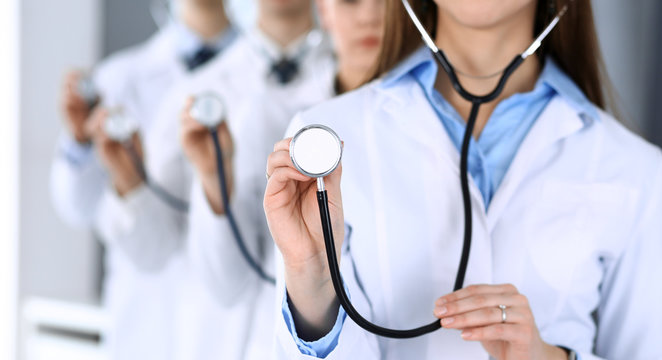 Group of doctors holding stethoscope head close-up. Physicians ready to examine and help patient. Medical help, insurance in health care, best treatment and medicine concept