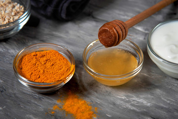 Natural face mask with turmeric powder, honey, oatmeal and yogurt. Natural cosmetics