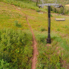 Square frame Sunny off season view in Park City ski resort with chairlifts over hiking trails