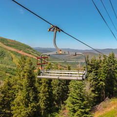 Square frame Metal chairlift against aerial view of mountain in Park City Utah at off season