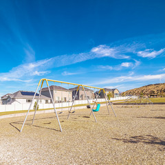 Fototapeta premium Square A-frame swings in a kids playground during day