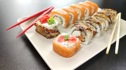 Various kinds of sushi food served on plate.