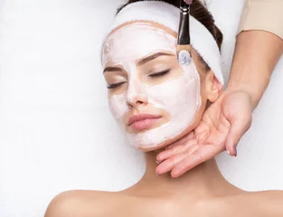 Peel and stick wall murals Beauty salon Woman receiving facial mask at beauty salon