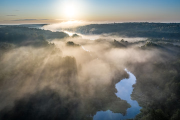 Fototapeta premium Wonderful mist over river in sunrise in autumn, aerial view