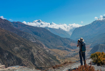 Fototapeta na wymiar Asian man trekker in valley of Everest base camp trekking route in Khumbu ,Nepal with snow mountain in background.