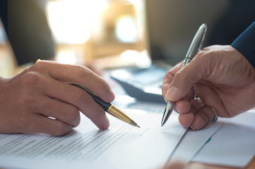 Close up of a business person who signs an agreement. Concept of contract signing.