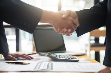 Business people shake hands after reaching a business agreement.