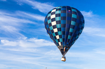 Obraz premium Hot air balloon with a burning burner scorched the envelope against the blue sky.