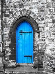 Fototapeta na wymiar A blue church door Penzance Cornwall with saturated blue and grey stonework