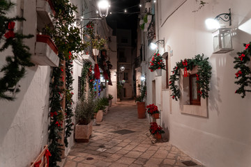 Night walk through the alleys decorated for the Christmas period of Locorotondo, a small town in the itria valley, southern Italy.