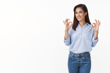 Excellent chocie. Sassy good-looking adult 30s woman pleased good result, show okay ok acceptance gesture, recommend perfect quality product, smiling pleased, rate best copyspace, white background