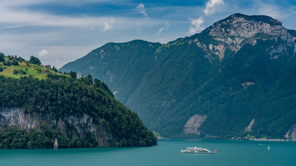 Switzerland, Panoramic view on green Swiss Alps and boat on lake Lucerne