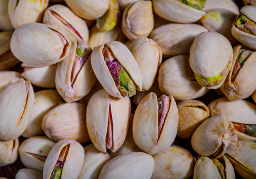 Fresh salted pistachios closeup, detailed macro image texture background