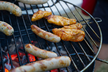 Grilled food on the grill with glowing charcoal