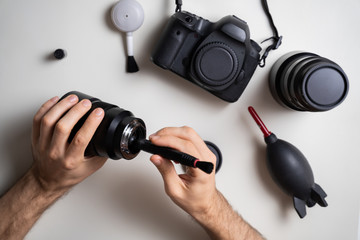 Man Cleaning Camera Lens