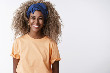Waist-up shot friendly and sincere, attractive african-american blond girl with afro hairstyle,...