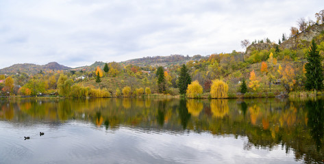 Autumn landscape with river and trees in the autumn seasons