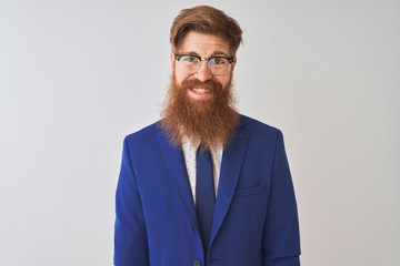 Young redhead irish businessman wearing suit and glasses over isolated white background with a happy and cool smile on face. Lucky person.