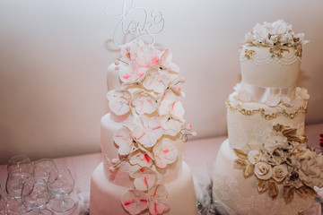 Pink cake decorated for a wedding celebration of love, making the classic wedding cake look with flowers decorations