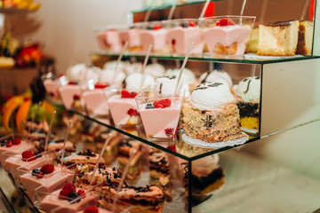 Wedding cake and cupcakes with berries. Cream cakes.