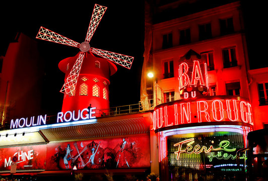 View of the Moulin Rouge (Red Mill) at night in Paris, France