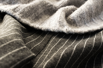 Fototapeta na wymiar Dettaglio macro outfit tessuti lana grigio a linee bianche