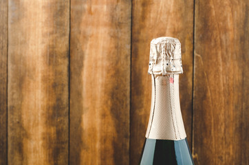 Bottle of champagne on a wooden background. Copy space. Green Bottle of champagne.