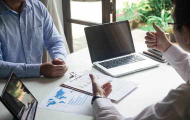 Image of two young businessmen using touchpad at meeting consultant lawyer concept.