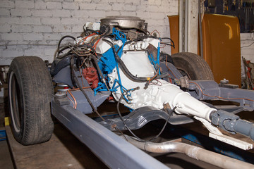 The repaired engine is mounted on the car frame.