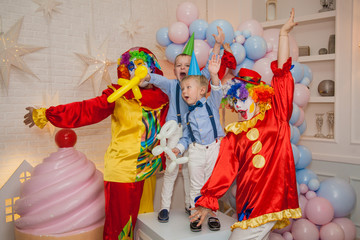 Circus clowns at the birthday party. Boys and clowns. Party for children.