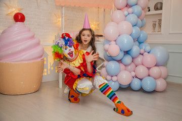 Obraz na płótnie Canvas Clown girl from the circus at the birthday party. Girl and the clown. Party for children.