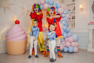 Fototapeta na wymiar Circus clowns at the birthday party. Boys and clowns. Party for children.