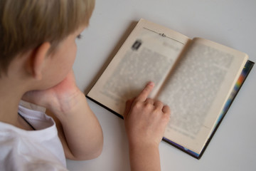 A child reading a book. Training. Children's books. Education of children.